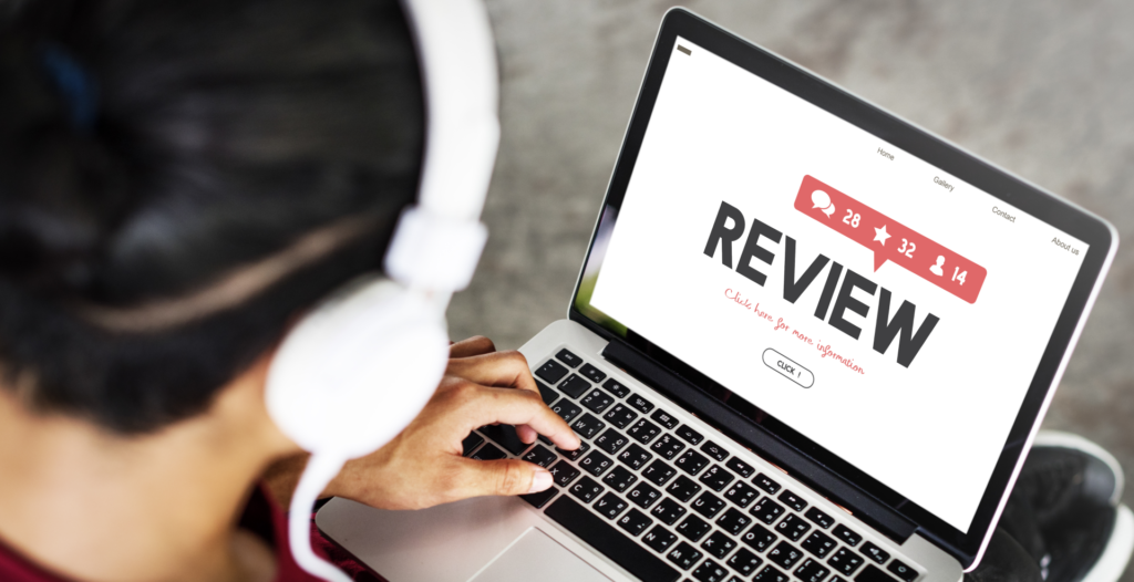 A person using a laptop with the word review on it.
