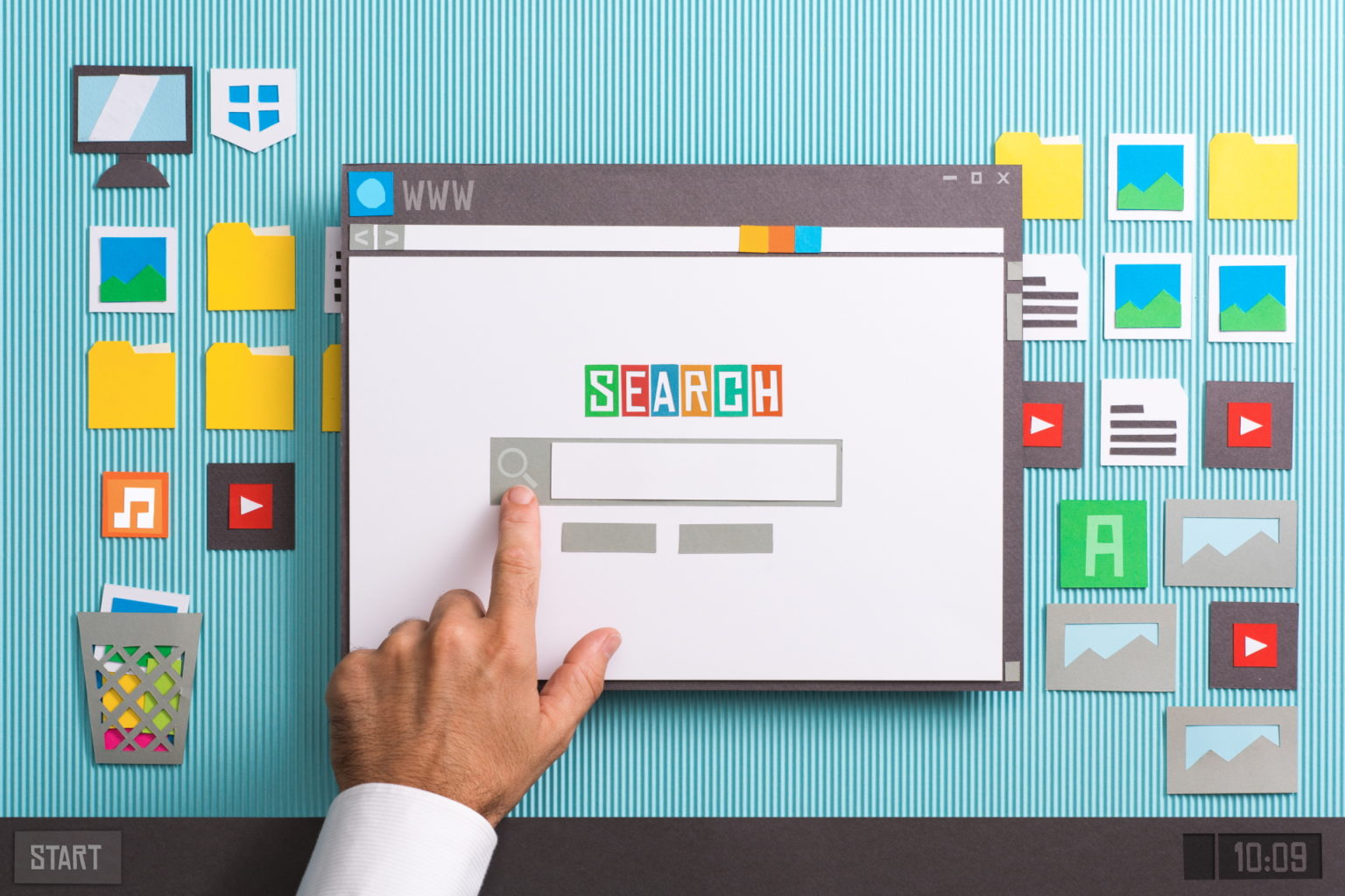 A hand is pointing at a search button on a computer screen.