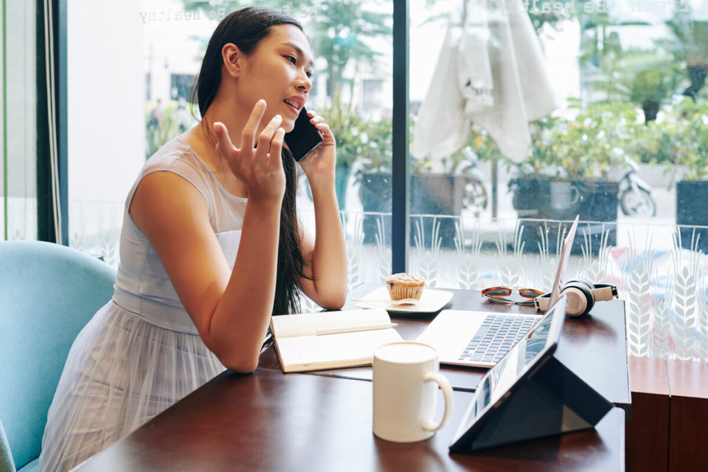 Woman making business phone call using VoIP