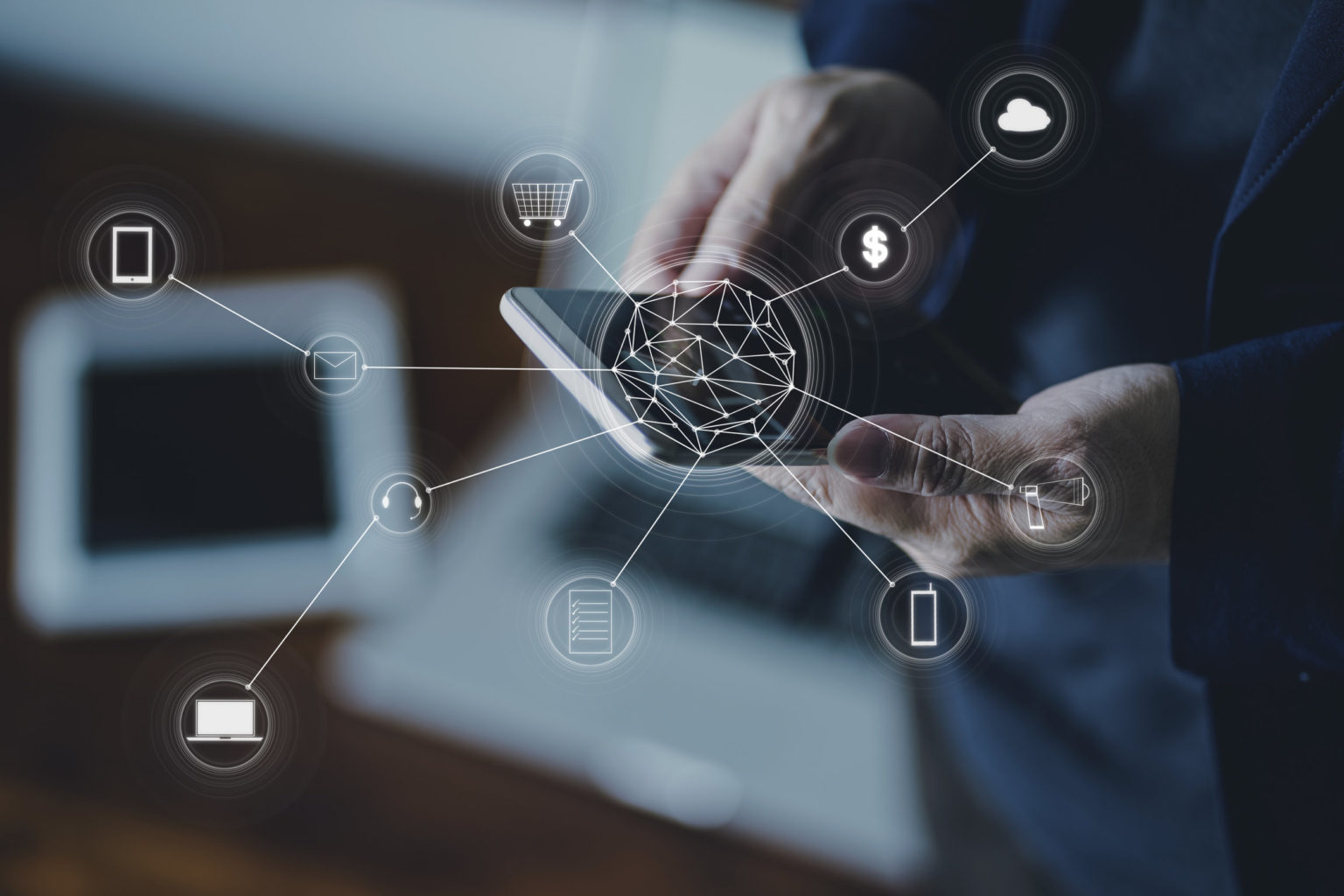 A man is holding a smartphone with social network icons on it.