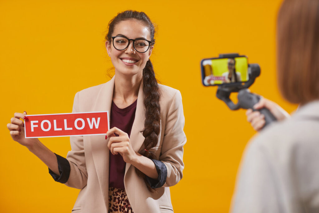 Contemporary Young Woman Holding Follow on social media