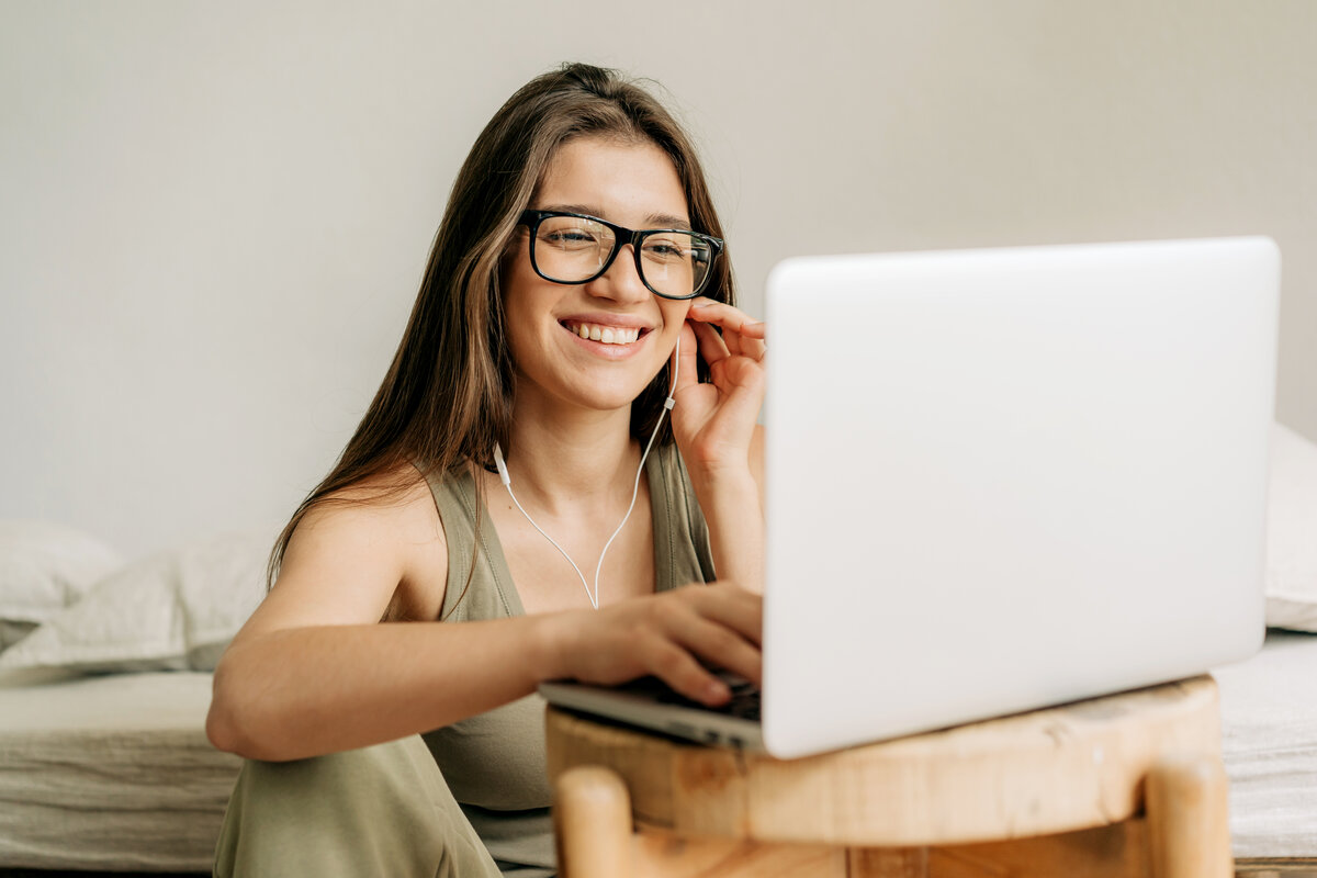 Smargasy Freelancer woman at online meeting using laptop and headphones.