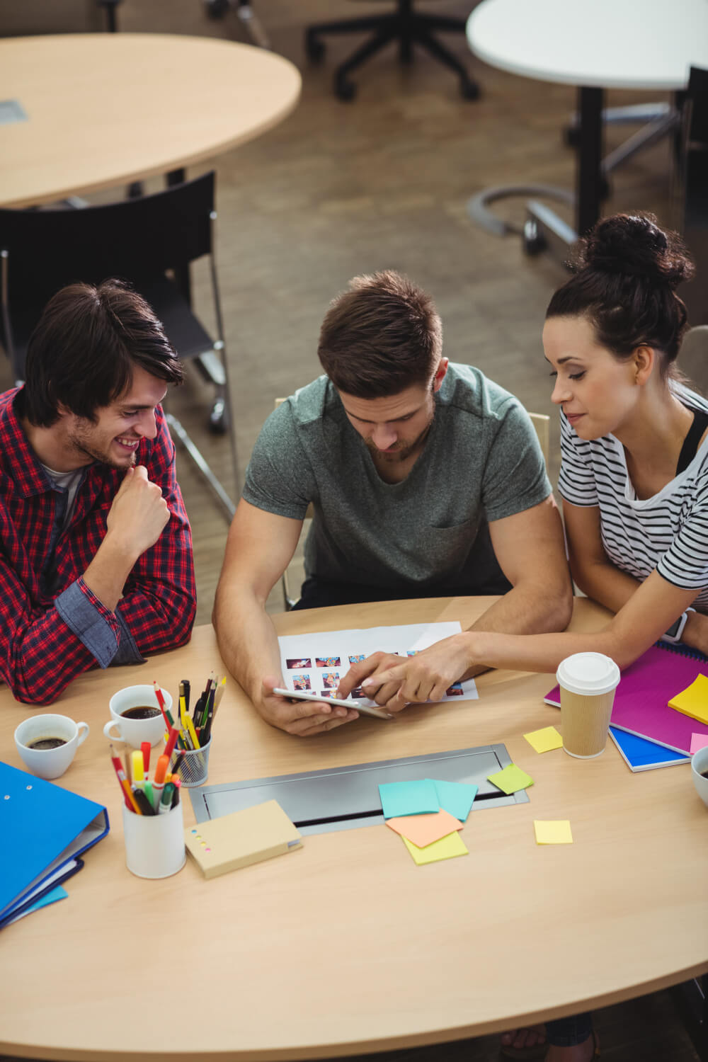 Four people sitting around a table in an office.