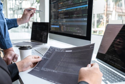 A group of people working on laptops in an office.