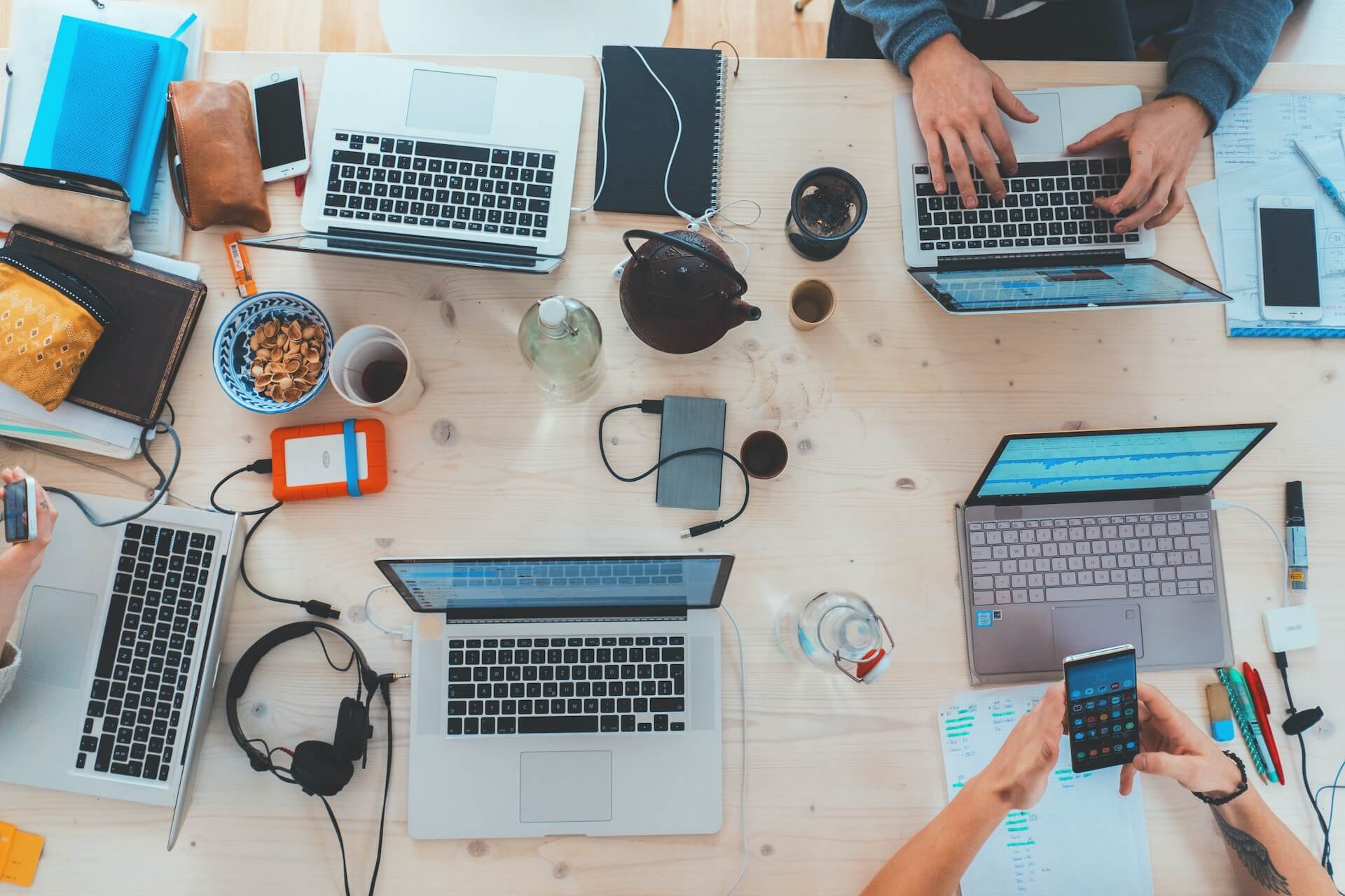 A group of people working on laptops at a table.