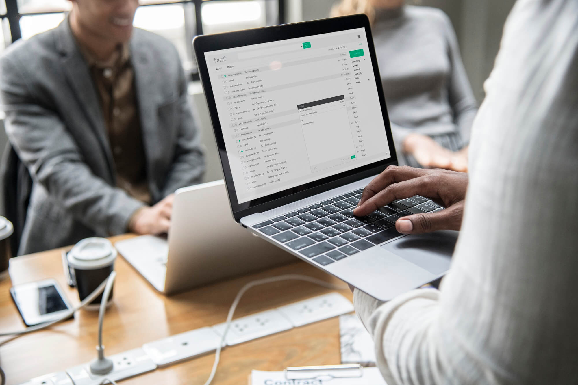 A person is using a laptop with a spreadsheet on it.