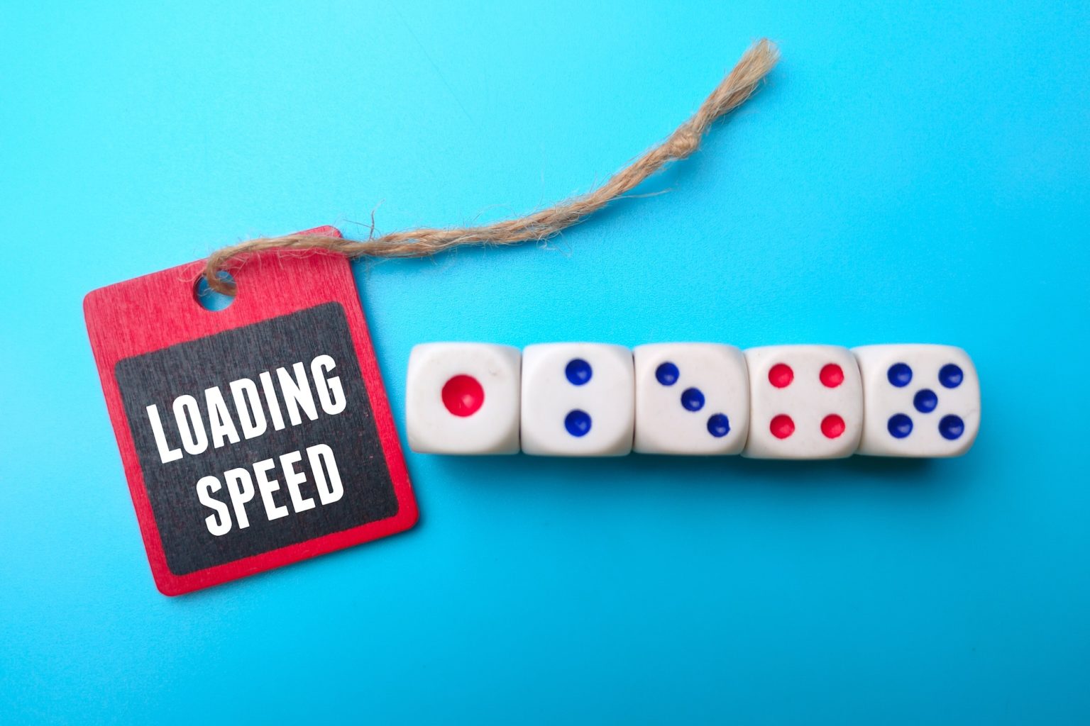 Dice with the word loading speed on a blue background.