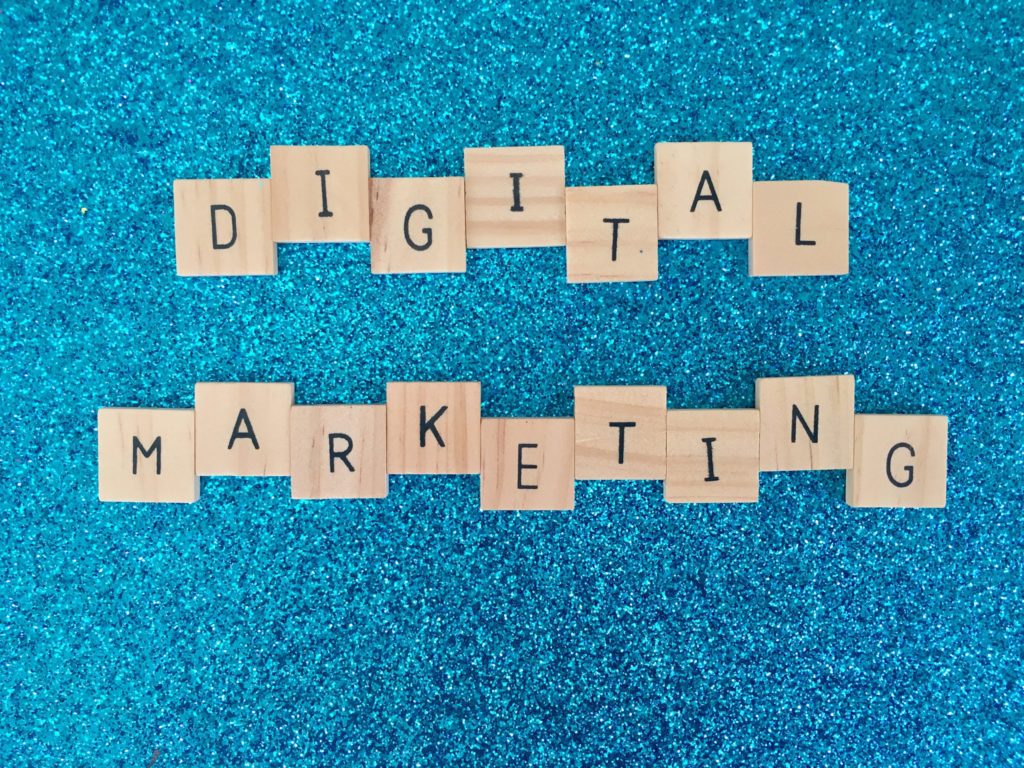 The word digital marketing spelled out on a blue background.